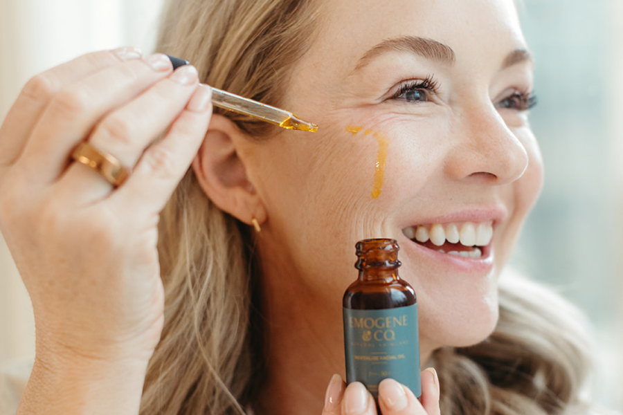 Woman applying facial oil to skin for lasting hydration in her dry skin care routine